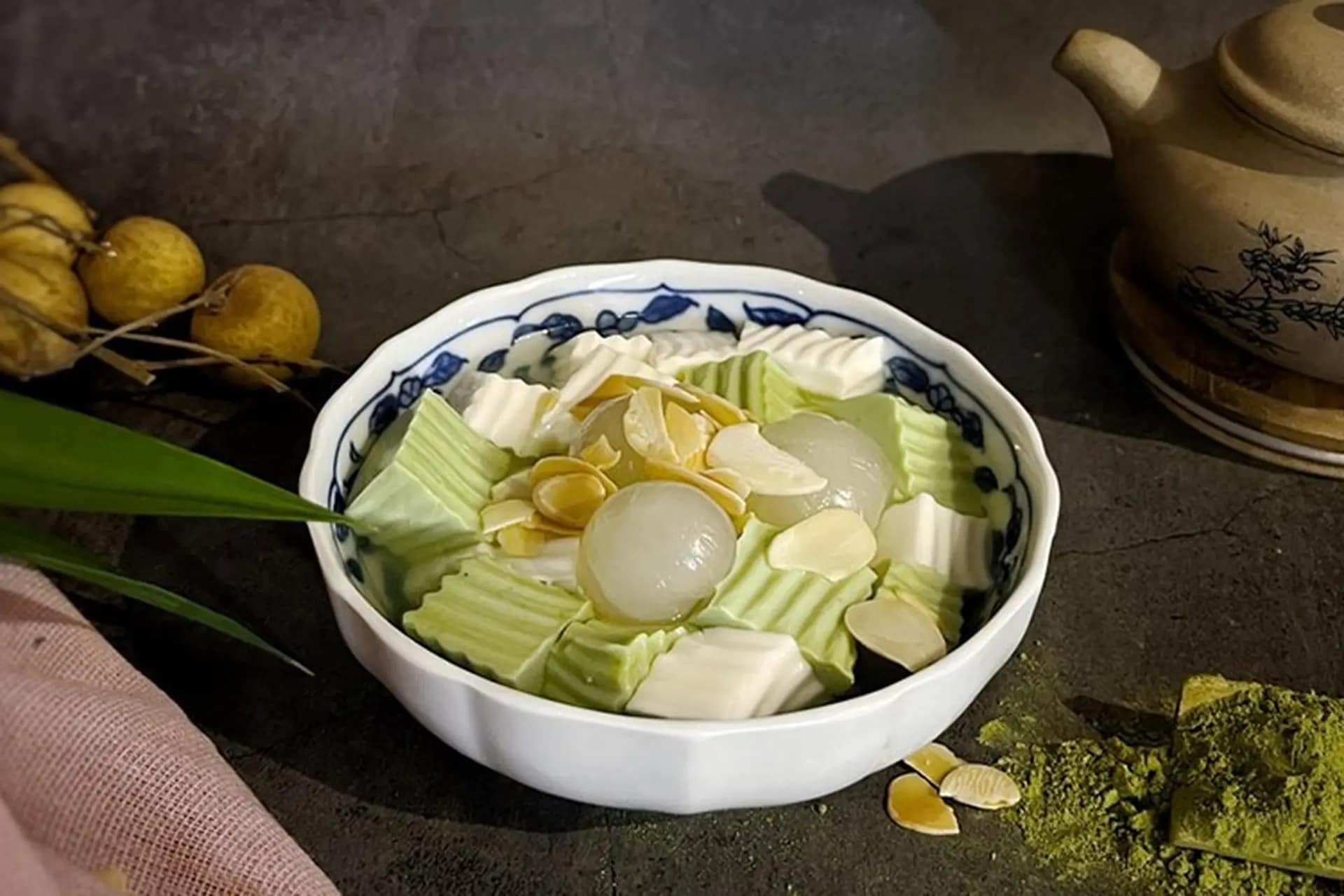 Coconut jelly cubes arranged with fresh longan, garnished with sliced almonds